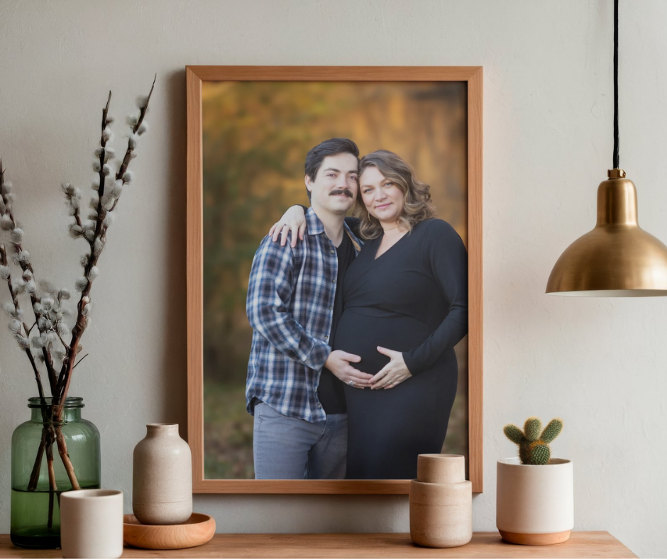 Maternity photography portraits in a frame and displayed above table.
